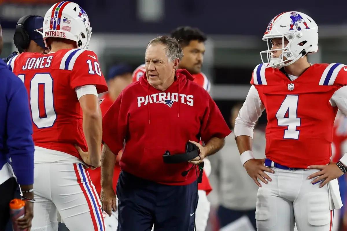 New England Patriots head coach Bill Belichick with quarterback Mac Jones (10) and quarterback Bailey Zappe (4)
